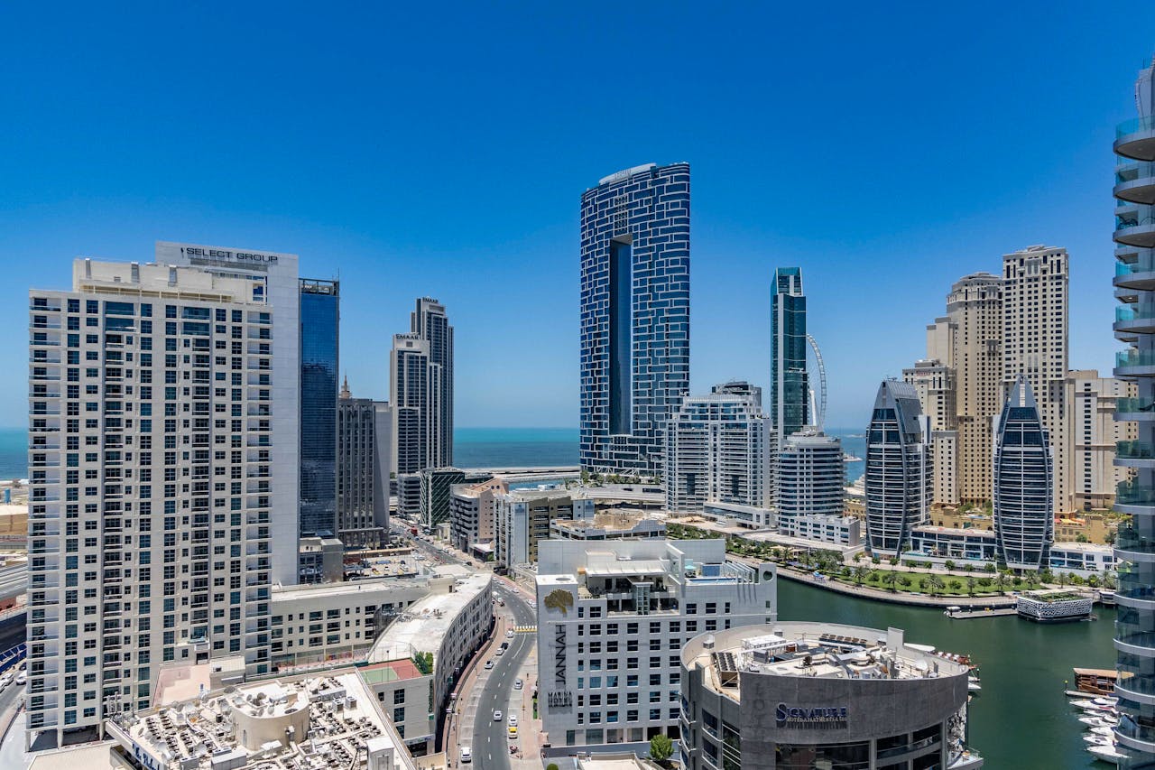 Home Stunning view of Dubai Marina's iconic skyscrapers and waterfront under a clear blue sky.